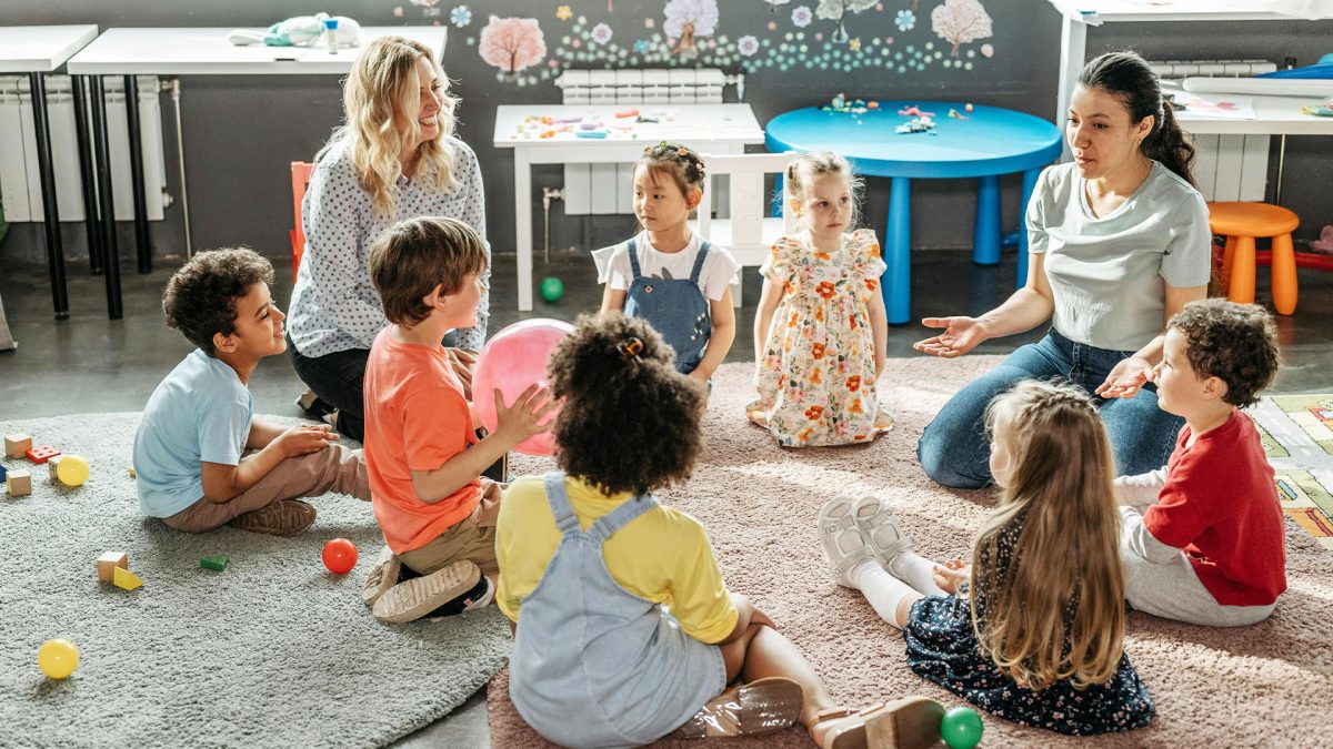 Groupe d'enfants assis par terre dans une structure d'accueil petite enfance