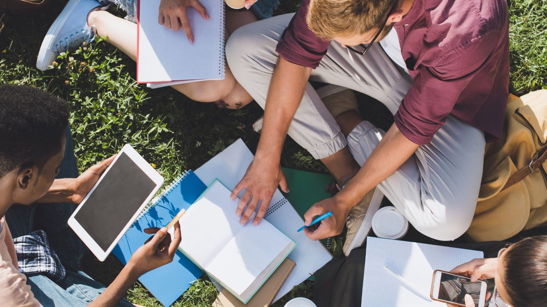 Des jeunes étudient ensemble dans un jardin